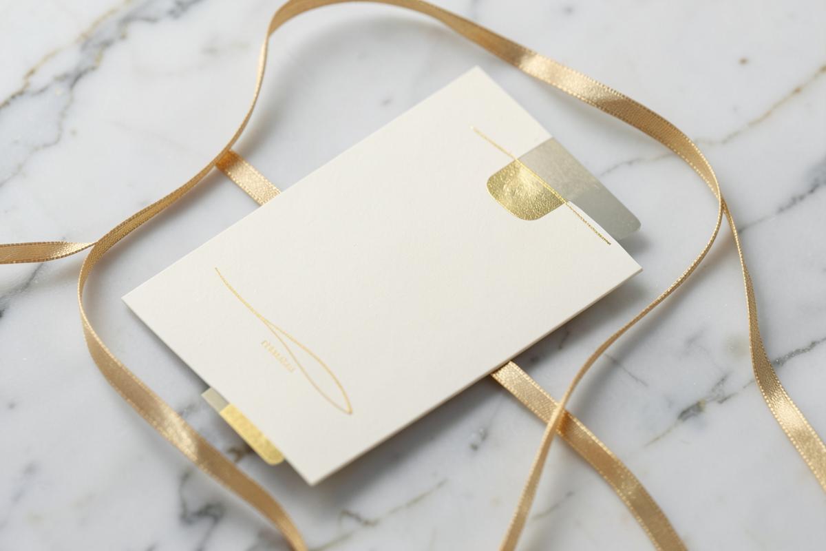 Cream and gold Nail Bar 12 gift card with a ribbon on marble